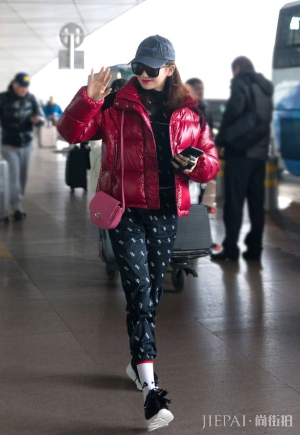 戚薇穿红色亮面羽绒服搭配玫红色皮包现身机场!
