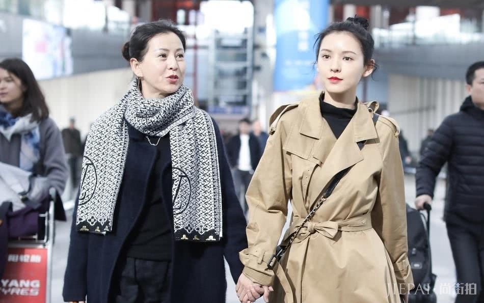 张予曦卡其色风衣搭丸子头牵手母亲走机场