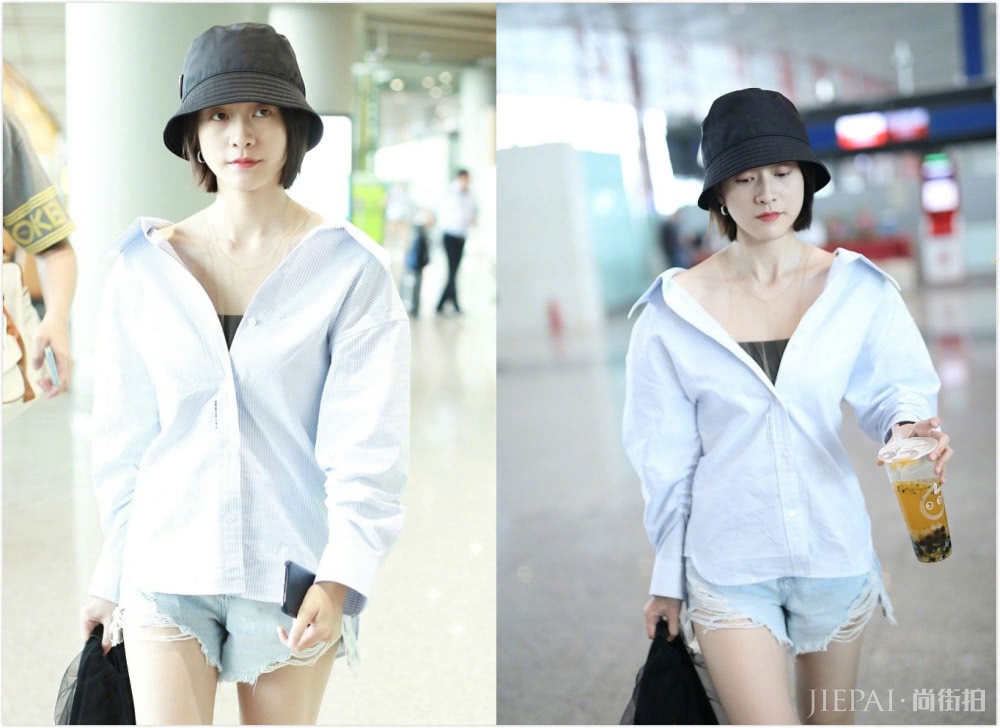 张雪迎机场街拍,穿大V领衬衫配牛仔短裤少女感十足