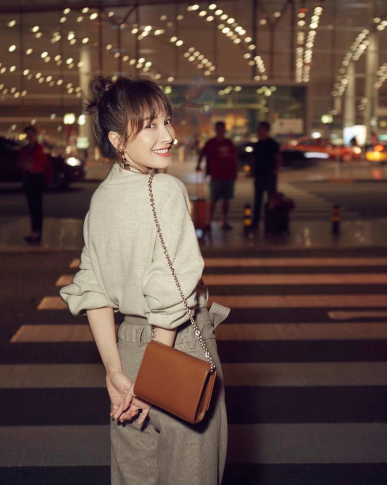 吴昕身穿燕麦色上衣，搭配拼色阔腿裤，时装周之旅秒变大长腿