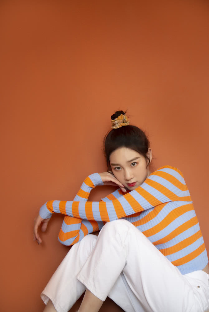李子璇穿橙白条纹上衣绑丸子头,尽显活力清新